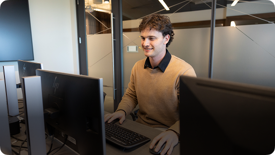 A man working at a computer in an office