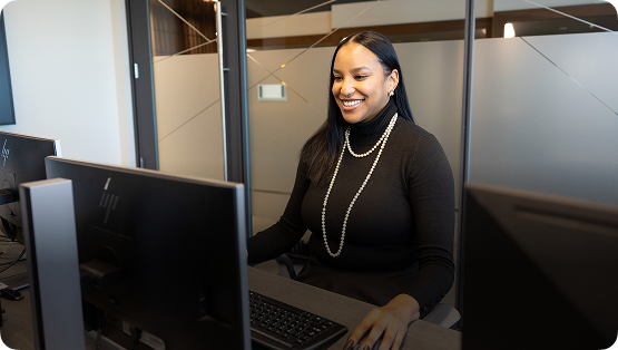 A woman working at a computer in an office